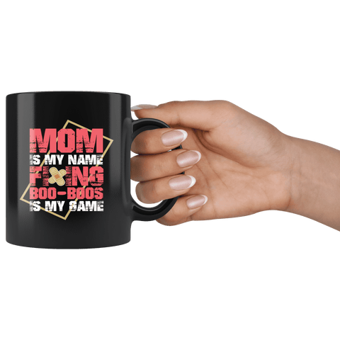 https://bingeprints.com/cdn/shop/products/mom-is-my-name-fixing-booboos-is-my-game-mug-funny-mothers-day-mama-coffee-cup-drinkware-teelaunch-732386_large.png?v=1579608004
